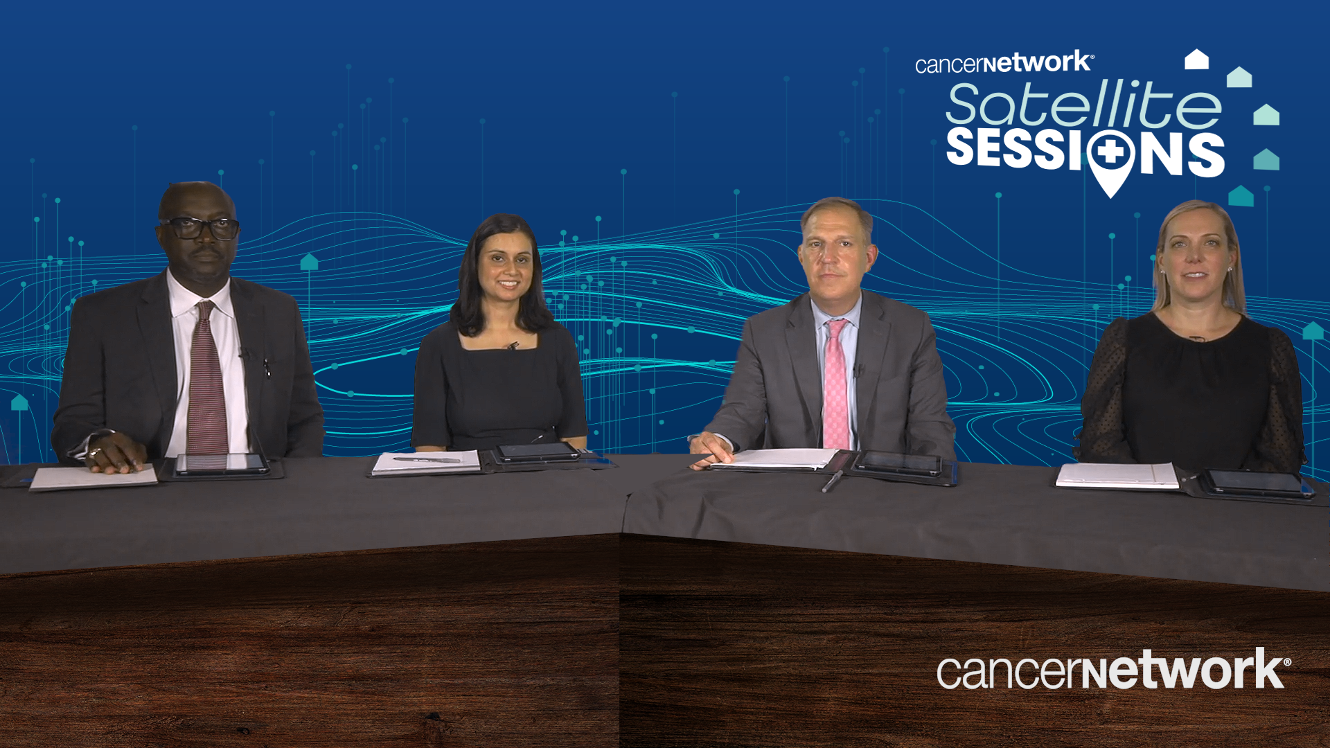 A panel of 4 experts on multiple myeloma seated at a long table